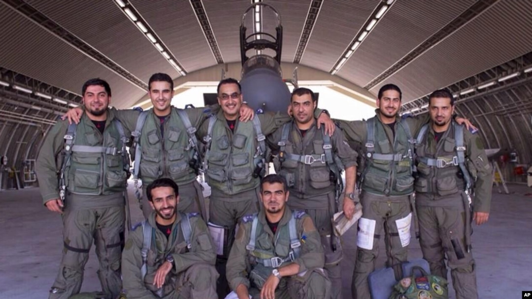Saudi pilots pose for a group portrait after taking part in U.S.-led coalition airstrikes on Islamic State militants and other targets in Syria, Sept. 24, 2014.