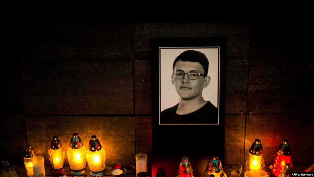 Candles and a portrait of Slovak investigative journalist Jan Kuciak