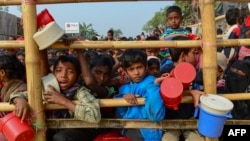 Rohingya refugees wait for food aid at Thankhali refugee camp in Bangladesh's Ukhia district on Jan. 12, 2018.