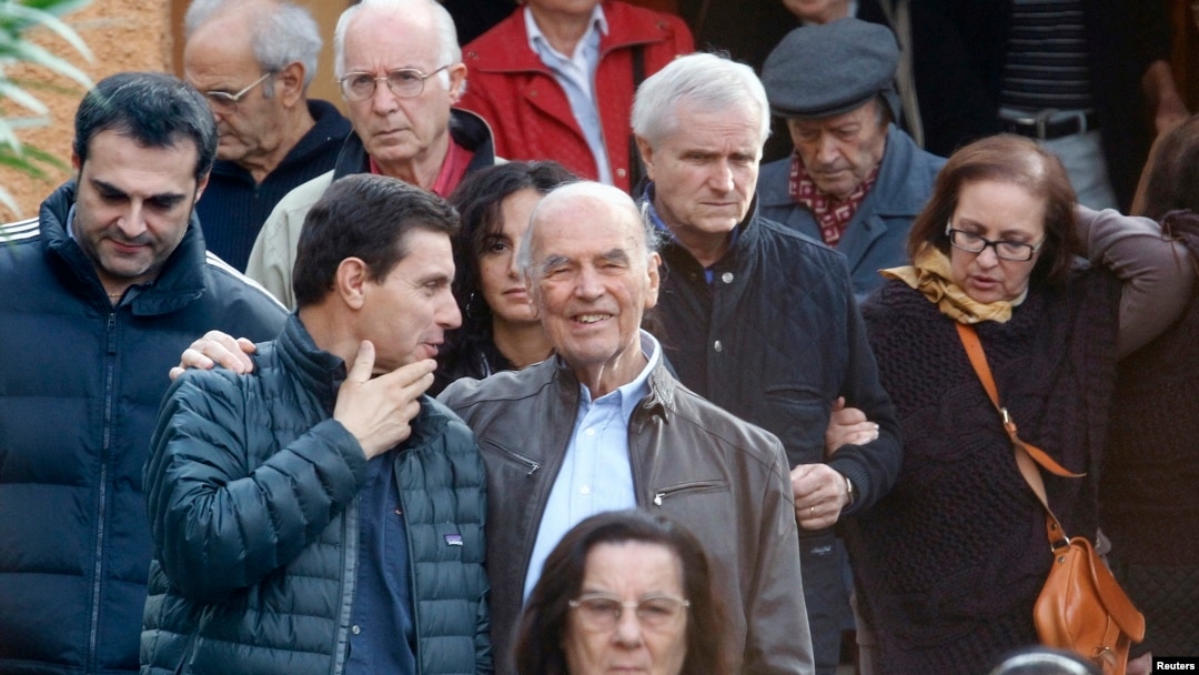 FILE - Convicted former Nazi SS officer Erich Priebke (C) and his lawyer, Paolo Giachini (L), are seen exiting a church after a mass in northern Rome October 17, 2010.