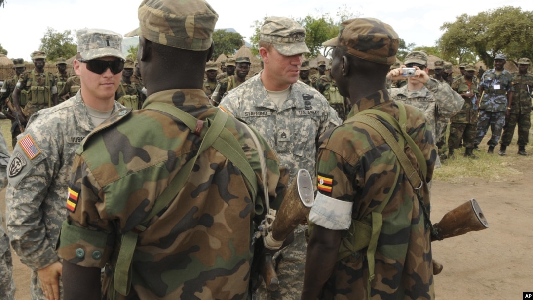 In this April 20, 2011 file photo, U.S. Army soldiers are seen with Uganda People's Defence Force soldiers at the closing ceremony for operation ATLAS DROP 11, an annual joint aerial delivery exercise, in Soroti, Uganda. While putting few U.S. 