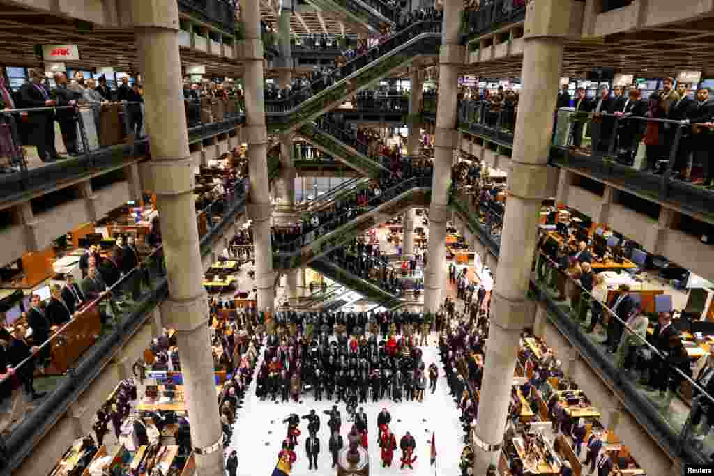 Staff members attend a Remembrance Service at the Lloyd's building in the City of London, Britain.