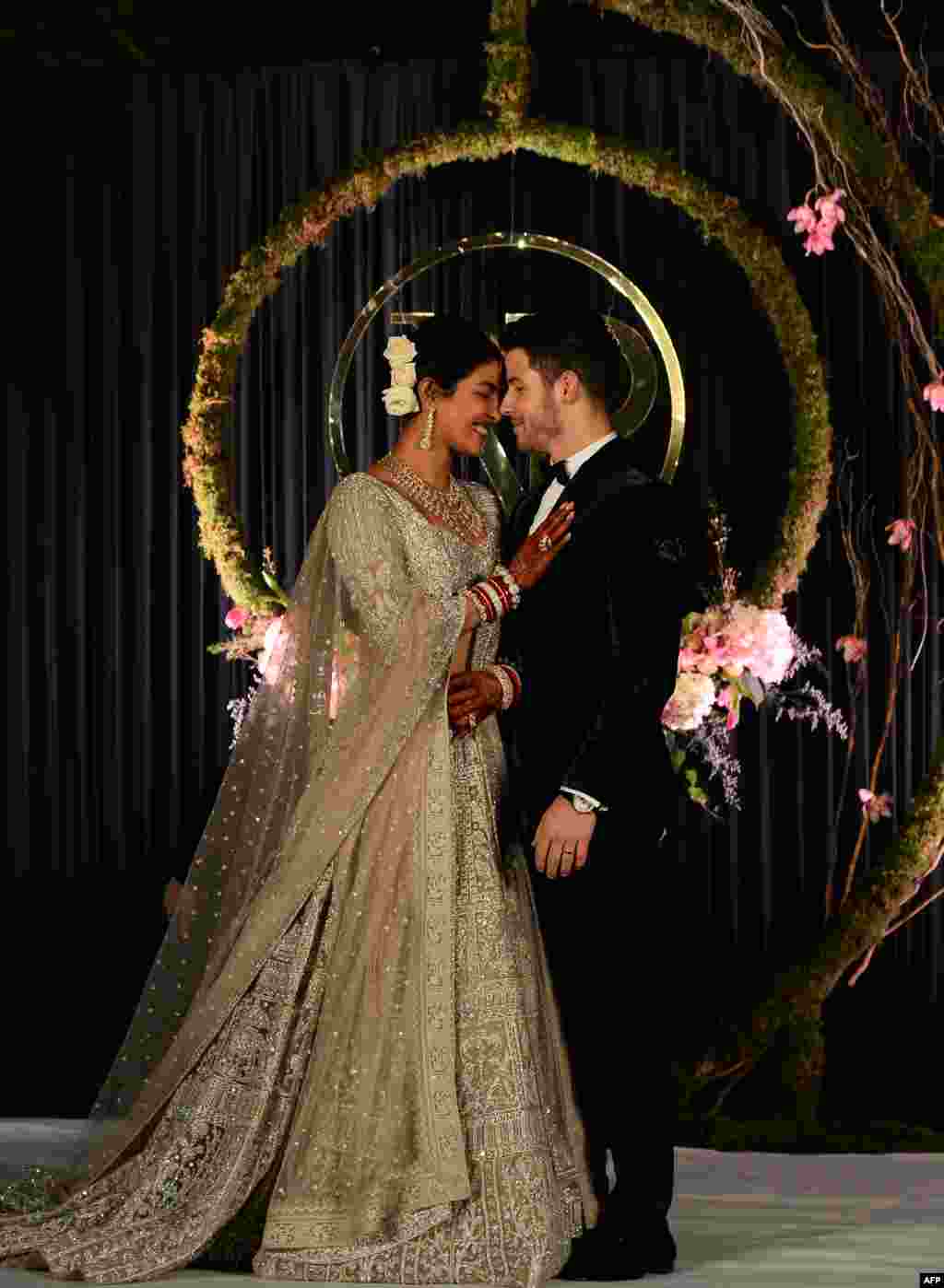 Indian Bollywood actress Priyanka Chopra (L) and U.S. musician Nick Jonas, who were recently married, pose for a photograph during a reception in New Delhi, India.
