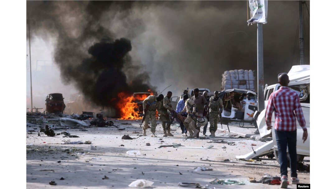 Somalian government forces evacuate their injured colleague, from the scene of an explosion in KM4 street in the Hodan district of Mogadishu, Oct. 14, 2017.