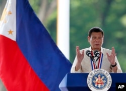 Philippine President Rodrigo Duterte gestures while speaking following a wreath-laying ceremony in observance of National Heroes Day, Aug. 29, 2016 at the Heroes Cemetery in suburban Taguig city, east of Manila.