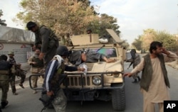 Afghan security forces take a wounded civilian man to the hospital after Taliban fighter's attack, in Kunduz city, north of Kabul, Afghanistan, Oct. 3, 2015. Three staff from MSF were killed and 30 were missing after an explosion near their hospital in Ku