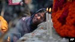 Bangladeshi relative of a victim cries in front of a monument erected in memory of the victims of Rana Plaza building collapse as they gather at the spot on its second anniversary in Savar, near Dhaka, Bangladesh, April 24, 2015.