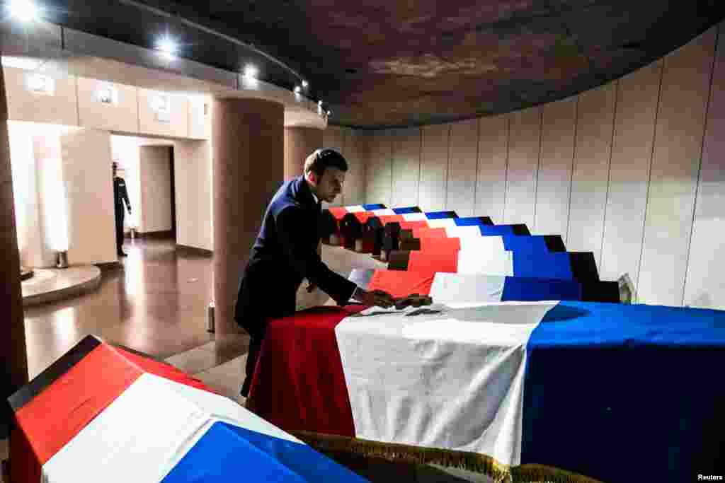 French President Emmanuel Macron pays his tribute to the flag draped coffin of Hubert Germain, a WWII veteran and the last 'Companion of the Liberation', during a burial ceremony in the crypt of the French resistance memorial of the Mont Valerien Suresnes, near Paris.