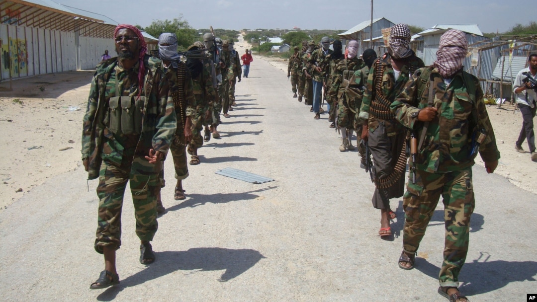 FILE - Members of Somalia's al-Shabab militant group patrol on the outskirts of Mogadishu, Somalia, March 5, 2012. 