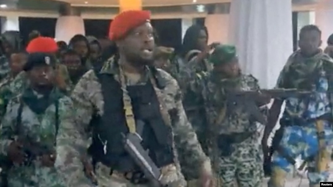 A man in military fatigues speaks as others stand next to him inside the Palace of the Nation during an attempted coup in Kinshasa, Democratic Republic of Congo, May 19, 2024 in this screen grab from a social media video. Christian Malanga/Handout via REUTERS 