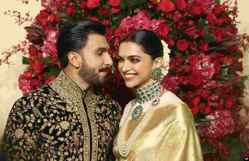 Bollywood actors Deepika Padukone, right, and Ranveer Singh pose at their wedding reception in Bangalore, India.