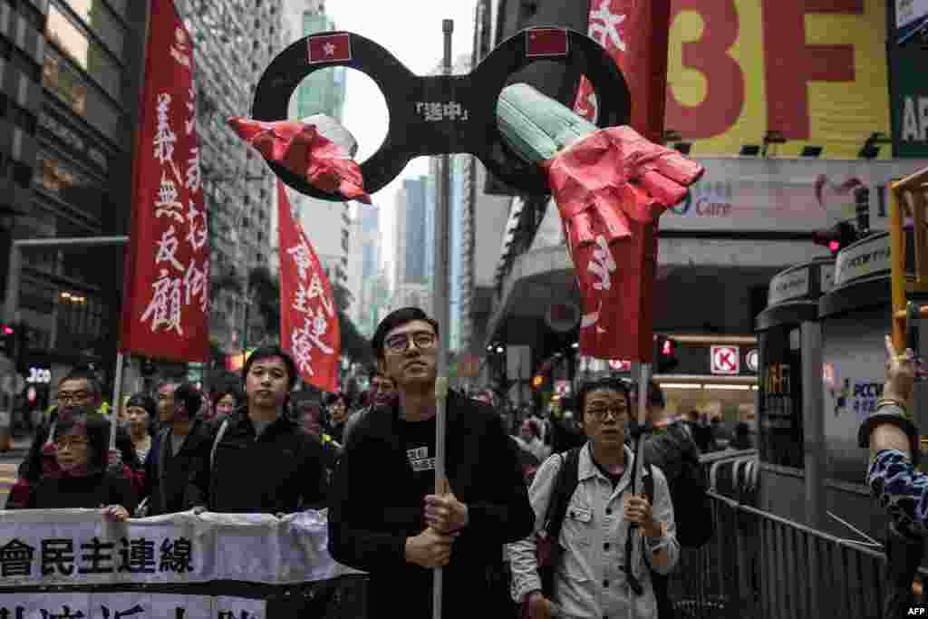 Protesters march along a street during a rally in Hong Kong to protest against the government's plans to approve extraditions with mainland China, Taiwan and Macau.