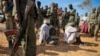 FILE - Alleged members of al-Shabab are blindfolded and guarded at a former police station by soldiers of the Somali National Army (SNA) in Kismayo, southern Somalia, Oct. 3, 2012.