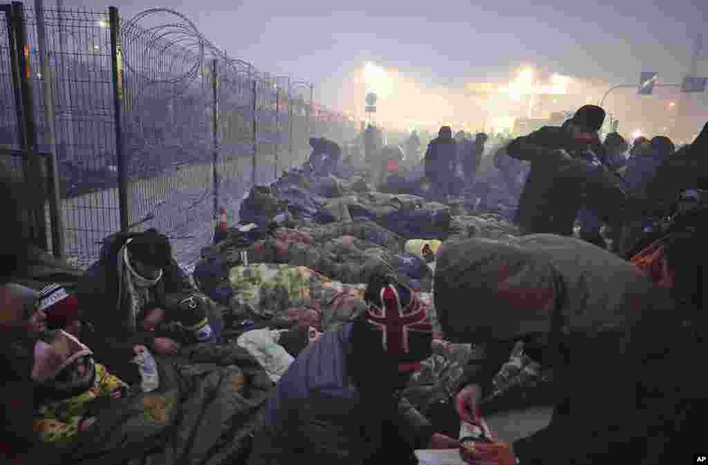 Migrants from the Middle East and elsewhere gather at the checkpoint "Kuznitsa" at the Belarus-Poland border near Grodno, Belarus, Nov. 15, 2021.