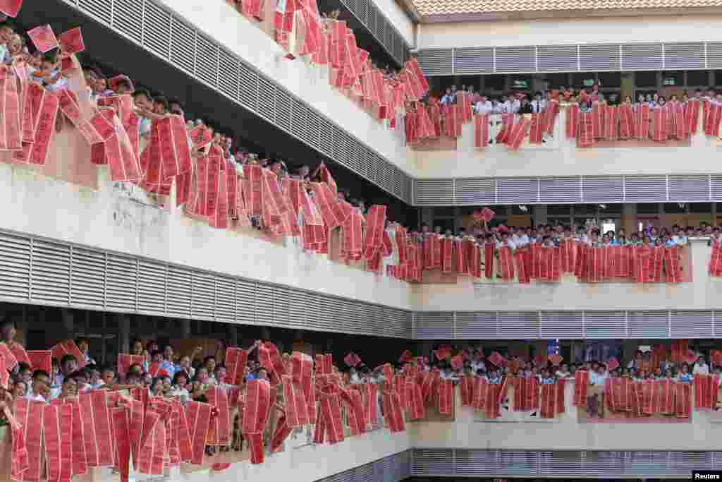 Students show off their calligraphy after a Chinese calligraphy event in conjunction with the upcoming Chinese Lunar New Year of the Pig, at Tsun Jin High School in Kuala Lumpur, Malaysia.