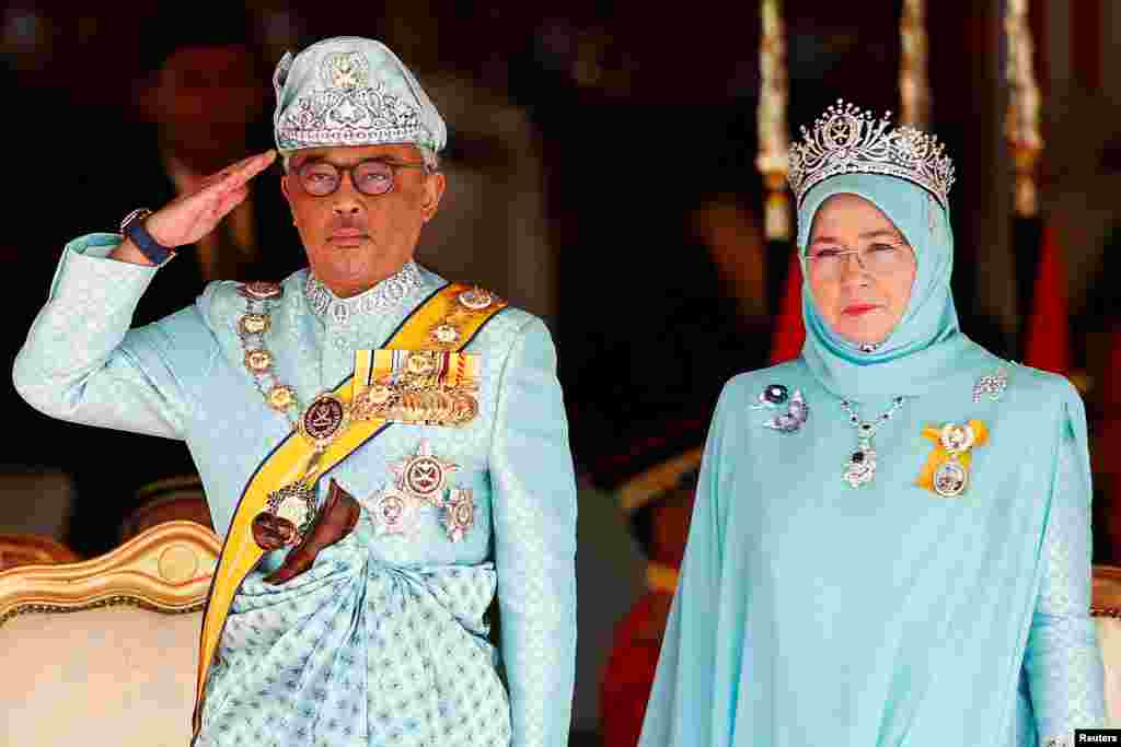 Malaysia's new King Sultan Abdullah Sultan Ahmad Shah and Queen Tunku Azizah Aminah Maimunah attend a welcoming ceremony at the Parliament House in Kuala Lumpur.