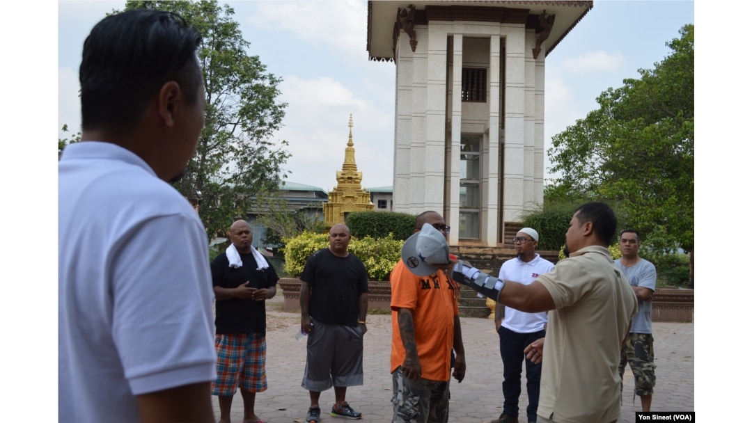 Borby Orn tells new deportees about the killing field site at Wat Snguon Pich pagoda in Cambodia.
