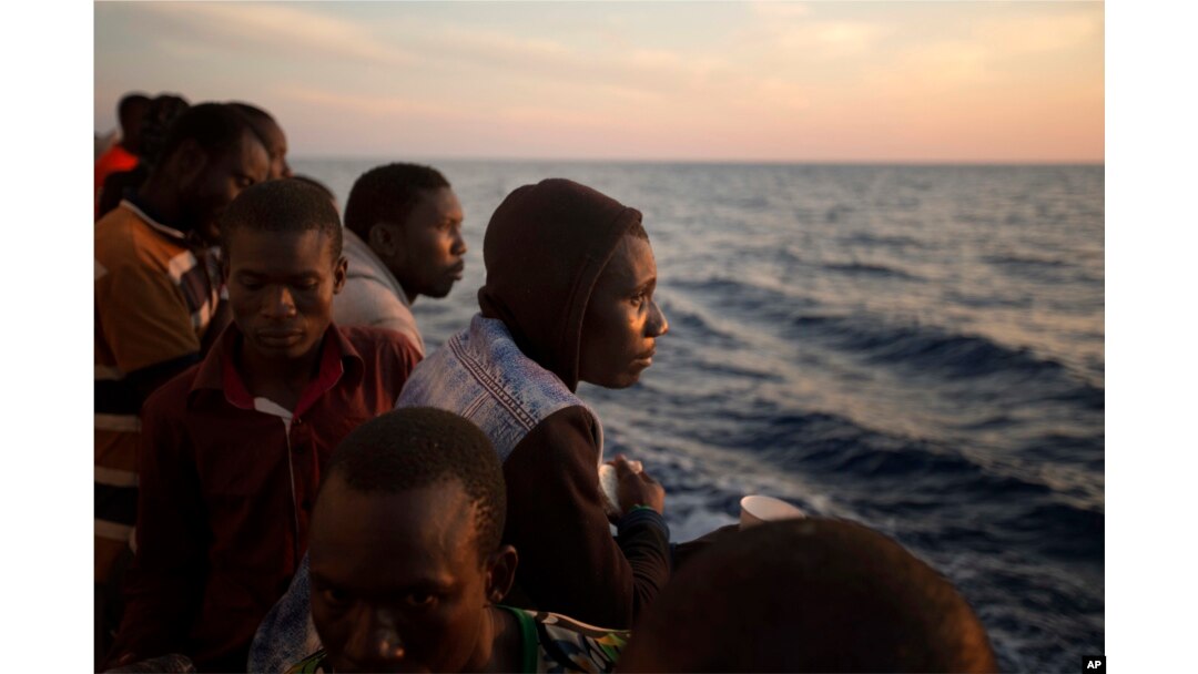Sub-Saharan migrants stand on the deck of the Golfo Azzurro rescue vessel as they arrive at the port of Pozzallo, Italy, June 17, 2017.
