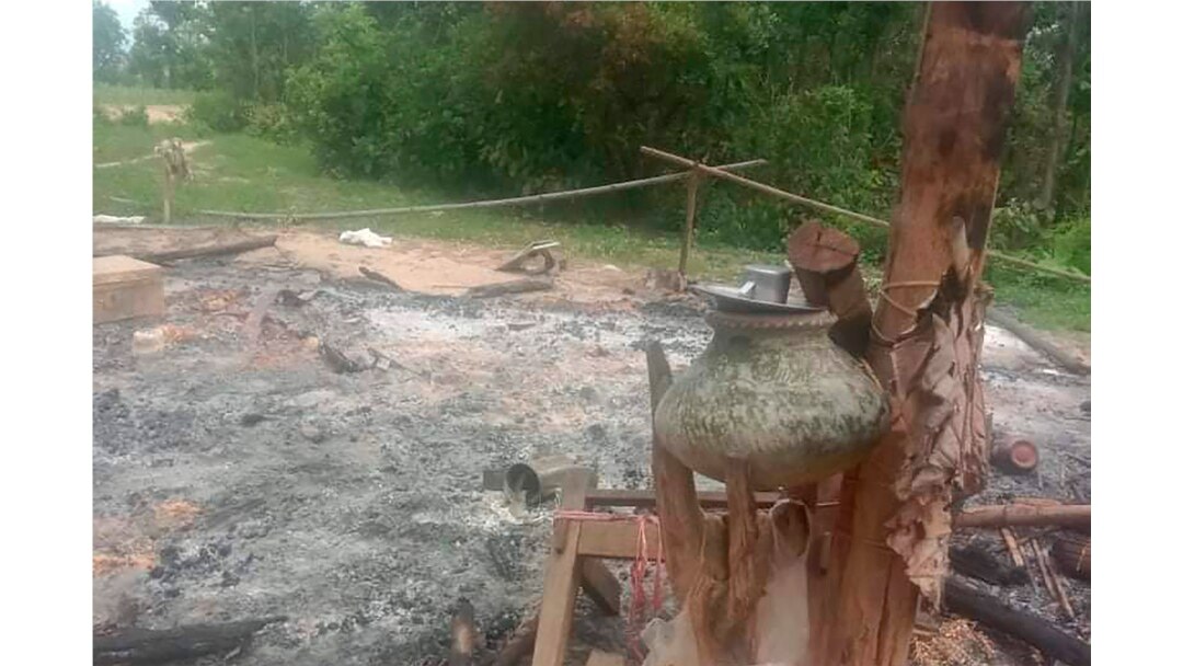 In this image provided by Myanmar Witness, which is undated and unverified but matches AP reporting and eyewitness testimony, a burned structure with household goods is seen outside Taung Pauk village in Kani township in Myanmar's Sagaing region.