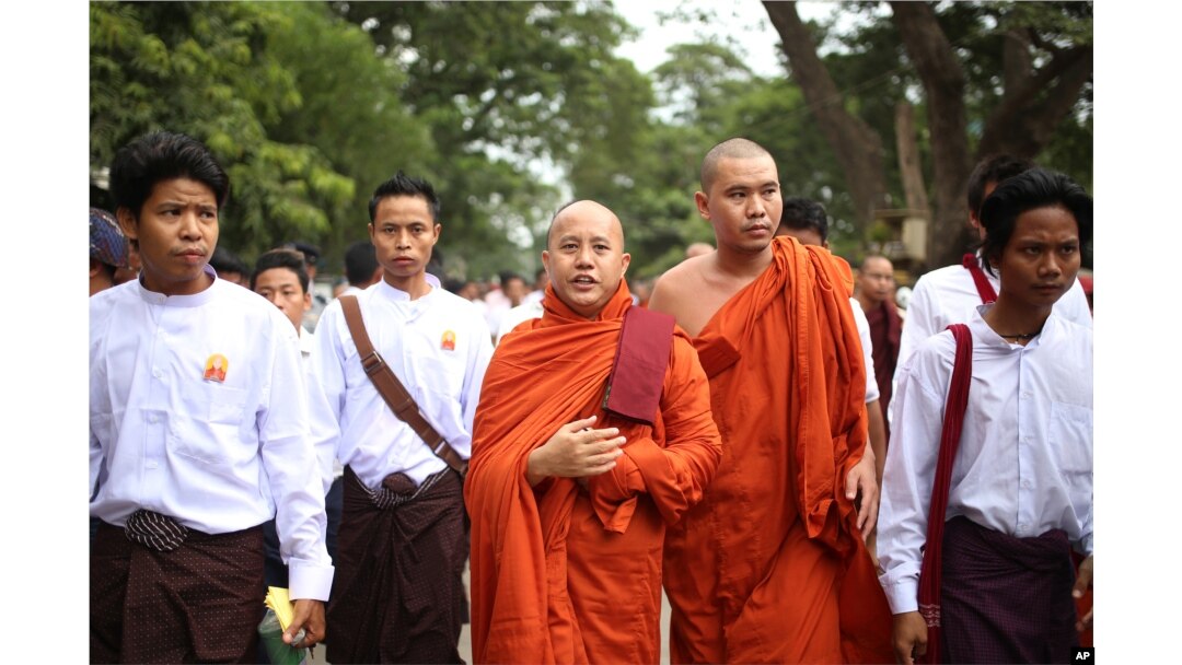 Nationalist Buddhist monk Wirathu, center, marches to celebrate newly imposed restrictions on interfaith marriages in Mandalay, the second largest city in Myanmar, Sept. 21, 2015.