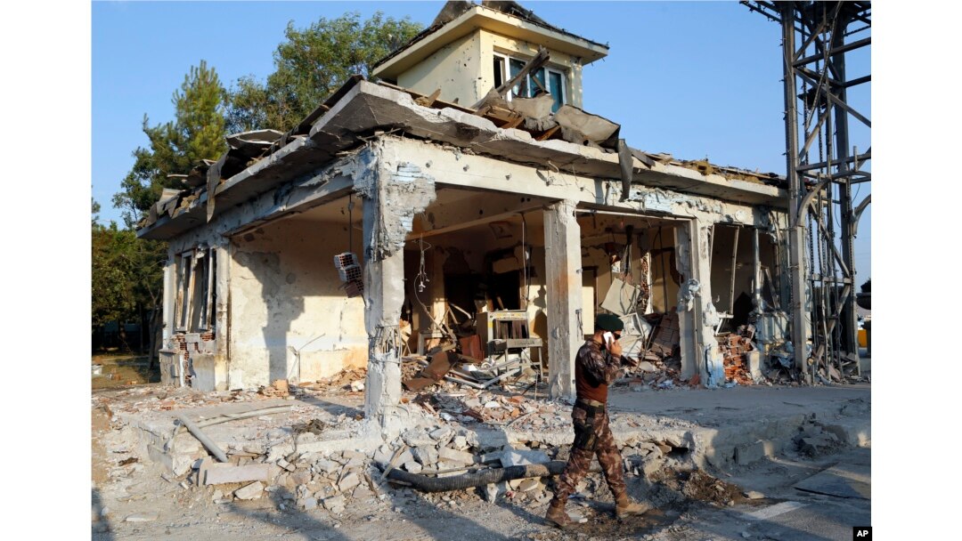 A Turkish special forces policemen walks in front of their damaged base, which was attacked by the Turkish warplanes during the failed military coup last Friday, in Ankara, Turkey, July 19, 2016.