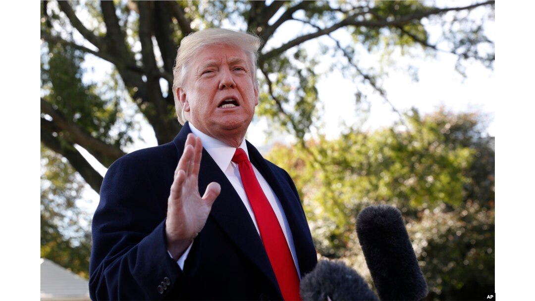 President Donald Trump stops to talk to the media before walking across the South Lawn of the White House in Washington, Oct. 22, 2018, to board Marine One helicopter for a short trip to Andrews Air Force Base, Md., en route to Houston.