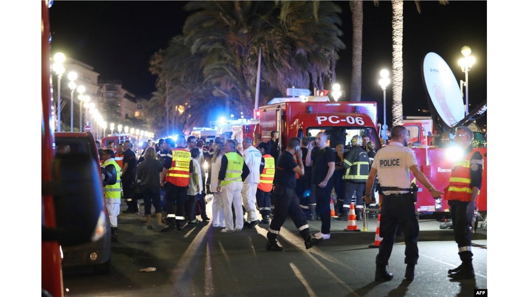 Police officers, firefighters and rescue workers are seen at the site of an attack on July 15, 2016, after a truck drove into a crowd watching a fireworks display in the French Riviera town of Nice.