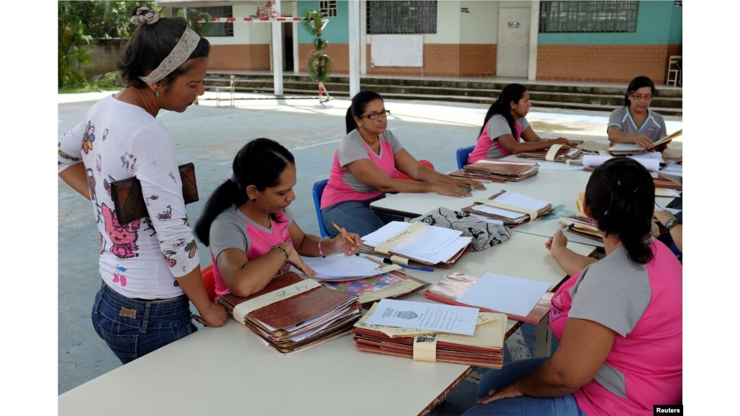 Teachers organize students' files on the first day of school, in Caucagua, Venezuela, Sept. 17, 2018.