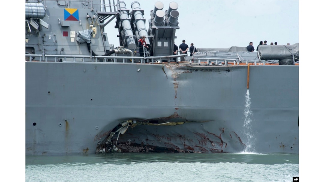 FILE - damage is visible as the guided-missile destroyer USS John S. McCain steers towards Changi naval base in Singapore following a collision with the merchant vessel Alnic MC.