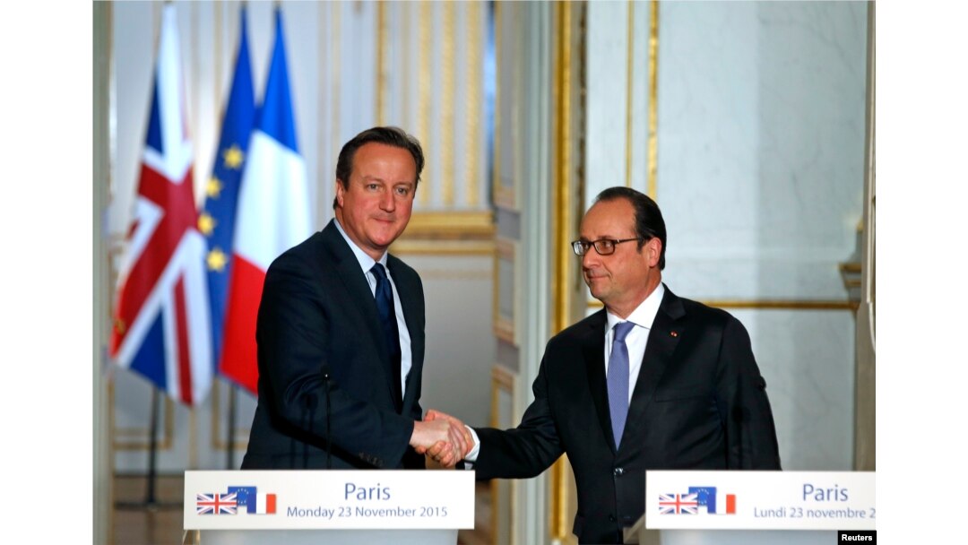 FILE - French President Francois Hollande (R) shakes hands with Britain's Prime Minister David Cameron during a joint news conference Nov. 23, 2015, at the Elysee Palace in Paris.