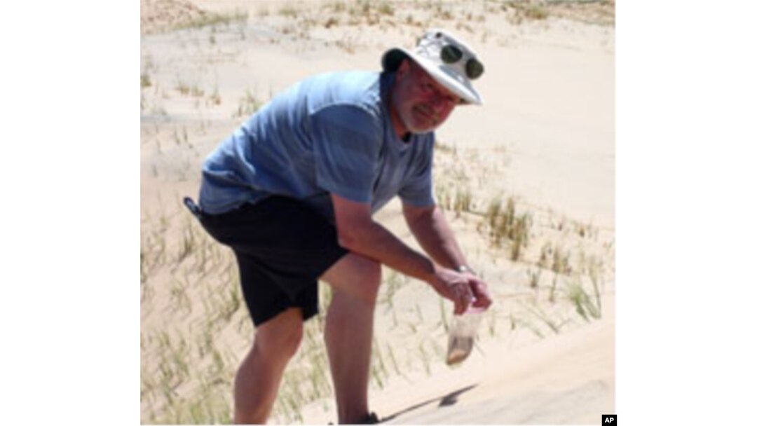 Geologist Michael Welland collects sand samples in central California.