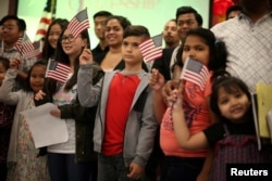 Niños recitan la promesa de lealtad durante durante una ceremonia de nuevos ciudadanos en Los Angeles, California, May 31, 2017.