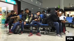 Cambodian workers at Phnom Penh International Airport waiting to board a plane to Seoul, South Korea. Cambodian workers in South Korea send an estimated $300 million home every year. (Poch Reasey/VOA Khmer)