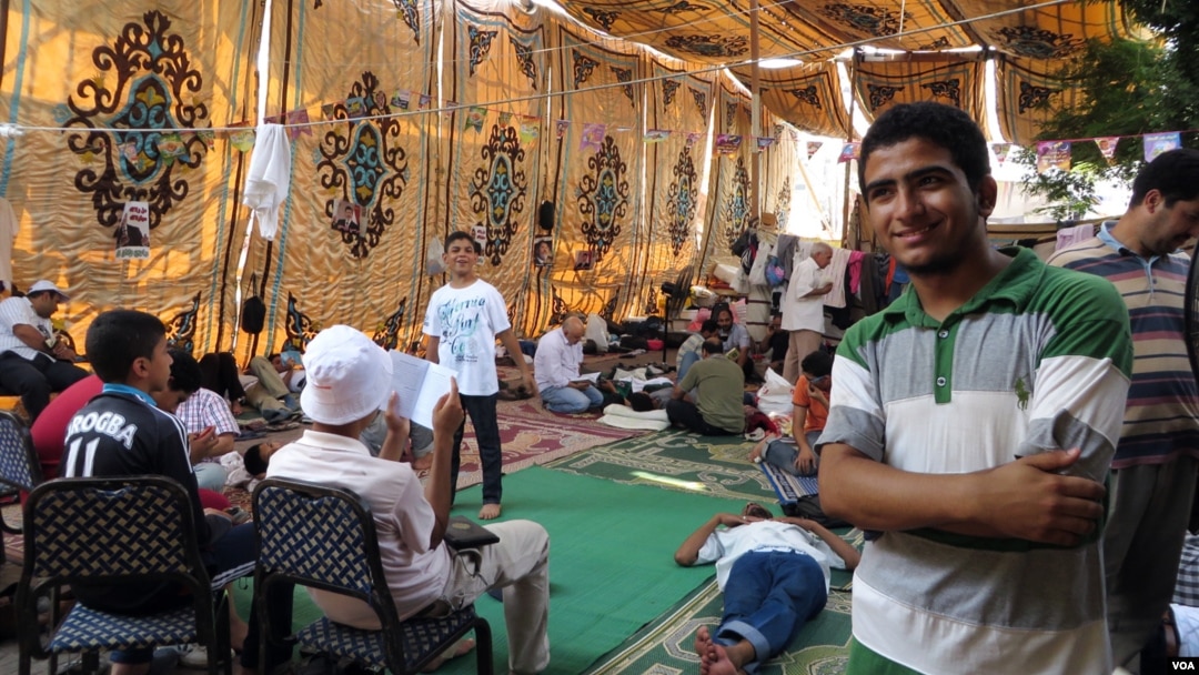 Fifteen-year-old Abdulrahman Usama has been staying in this tent for nearly a month and says he won't go back to school until the former president is reinstated. (Heather Murdock for VOA)