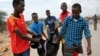 People carry away the body of a man killed in a suicide car bomb attack, near the defense ministry compound in Mogadishu, April 9, 2017. 