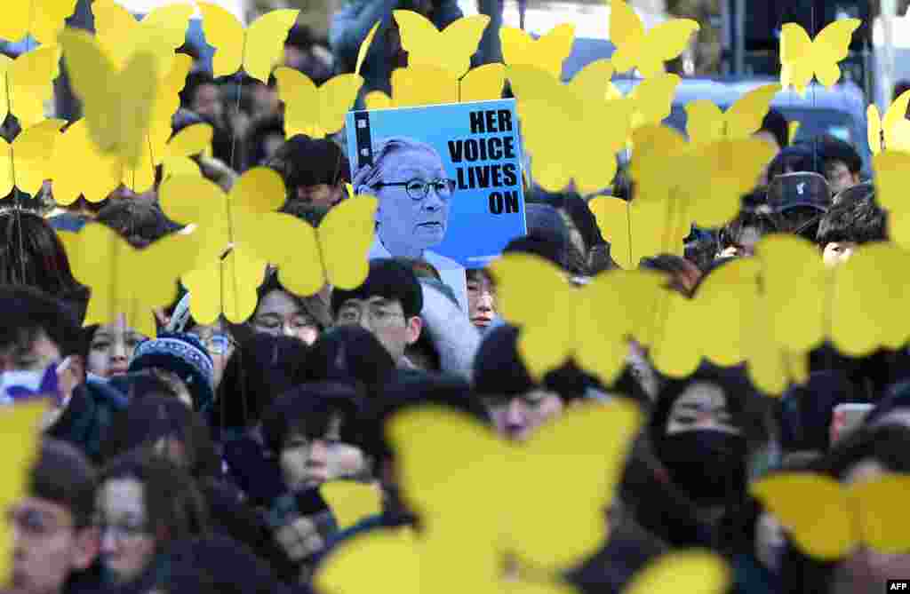 Mourners hold paper cutouts of yellow butterflies, symbols of sexual slavery victims, during a funeral ceremony of former South Korean "comfort woman" Kim Bok-dong, who was forced to serve as a sex slave for Japanese troops during World War II, near the Japanese embassy in Seoul, Feb. 1, 2019.