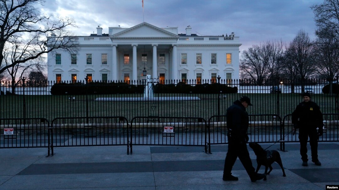 FILE - Secret Service Uniformed Division officers patrol in front of the White House, Washington, D.C., Jan. 20, 2015.
