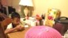 Bu Say Wah, preparing for a day at school, digs into not only a bowl of rice but also a serving of Corn Pops cereal at his home in Fort Wayne, Indiana. (C. Presutti/VOA)