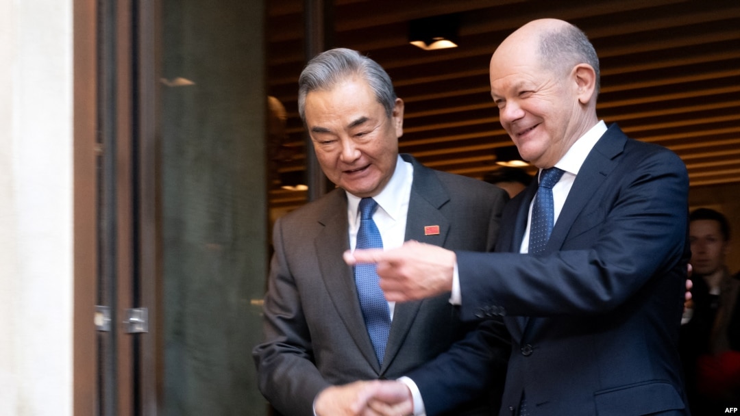 German Chancellor Olaf Scholz and Chinese Foreign Minister Wang Yi shake hands during a bilateral meeting during the 61st Munich Security Conference (MSC) in Munich, Feb. 15, 2025. 