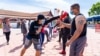 People practice MuayThai with a group of professional MuayThai instructors during a Free Self Defense Muay Thai Class, a martial art training against Asian hate crimes at Wat Thai Los Angeles, April 15, 2021. 