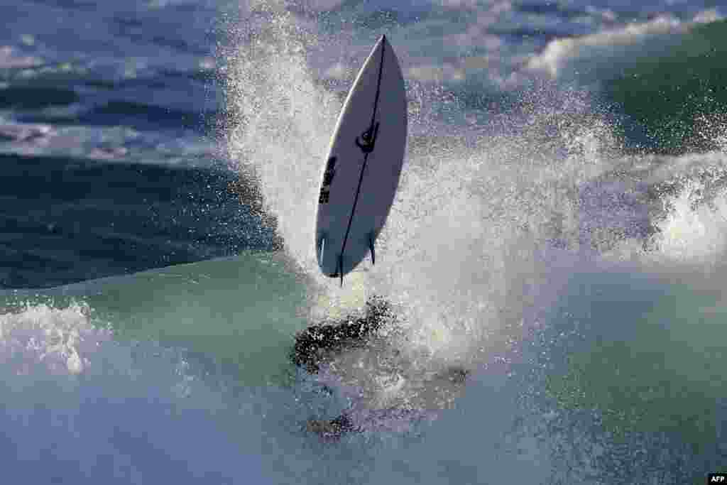 France surfer Marco Mignot rides a wave during the Men's QS 3,000 of the World Surf League SEAT Pro Netanya qualification in the Israeli coastal city of Netanya.