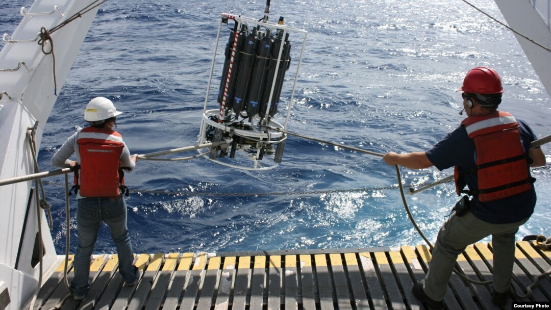 MBARI Scientists aboard Research Vessel Western Flyer shown recovering a water sampling device in the North Pacific Ocean, which is used to collect algae. (photo credit: Adam Monier)