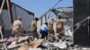 Libyan officials investigate the bombing of a detention center holding civilian migrants that killed dozens of people and injured more than 130, pictured on July 3, 2019. (H. Murdock)