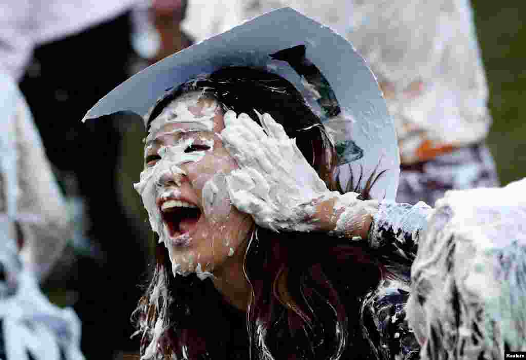 Students from St. Andrews University are covered in foam as they take part in the traditional 'Raisin Weekend' in the Lower College Lawn, at St Andrews in Scotland, Britain.