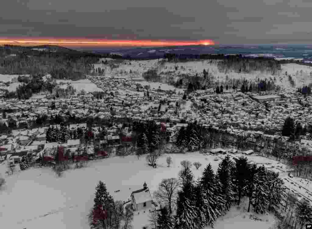The sun sets in Oberreifenberg near Frankfurt, Germany, Jan. 12, 2022.