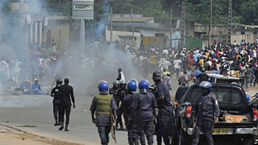 Ivory Coast police loyal to incumbent president Laurent Gbagbo face supporters of Alassane Ouattara, who has claimed to have won last month's presidential election, during a protest in a street in Abidjan on Dec 16, 2010