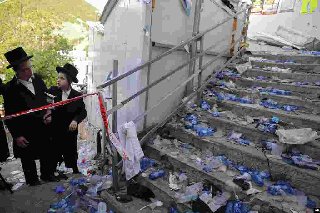 Ultra Orthodox Jews look at the scene where dozens of people were killed and 100s were injured in a stampede attended by tens of thousands of ultra-Orthodox Jews during Lag BaOmer festival at Mt. Meron in northern Israel.