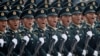 FILE - Soldiers of People's Liberation Army march in formation past Tiananmen Square during the military parade marking the 70th founding anniversary of People's Republic of China, on its National Day in Beijing, Oct. 1, 2019.