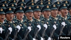 FILE - Soldiers of People's Liberation Army march in formation during the military parade marking the 70th founding anniversary of People's Republic of China, on its National Day in Beijing, Oct. 1, 2019.