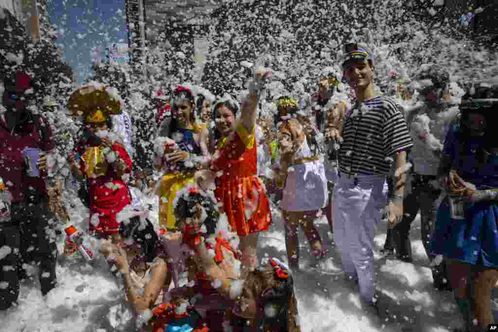 Medical school graduates dance during their class' graduation parade in Rosario, Argentina.
